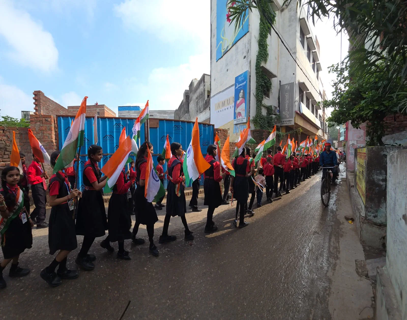 The school rally winds along the road, flags high